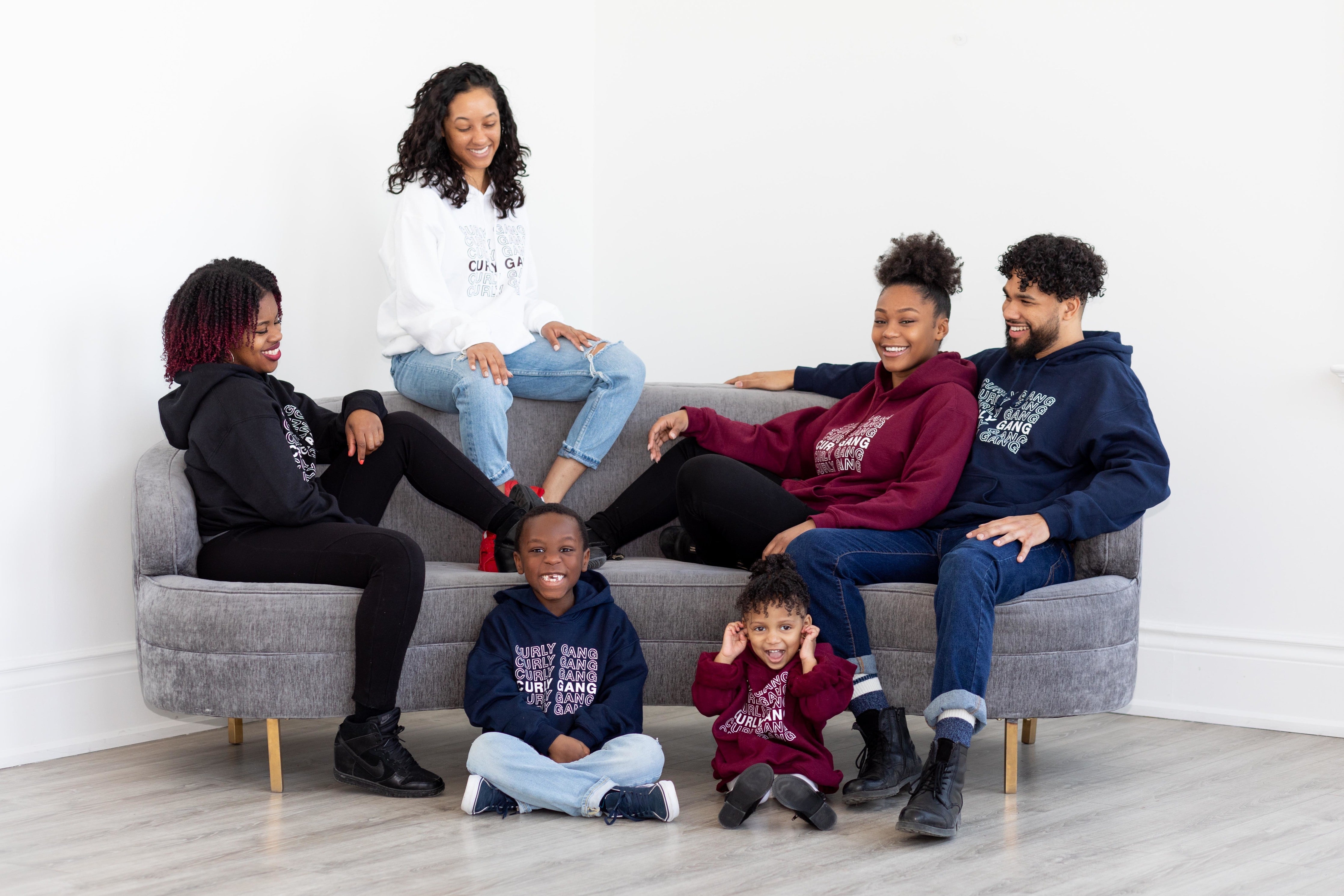 group of black men, women and children in Curly Gang Unisex Hoodies